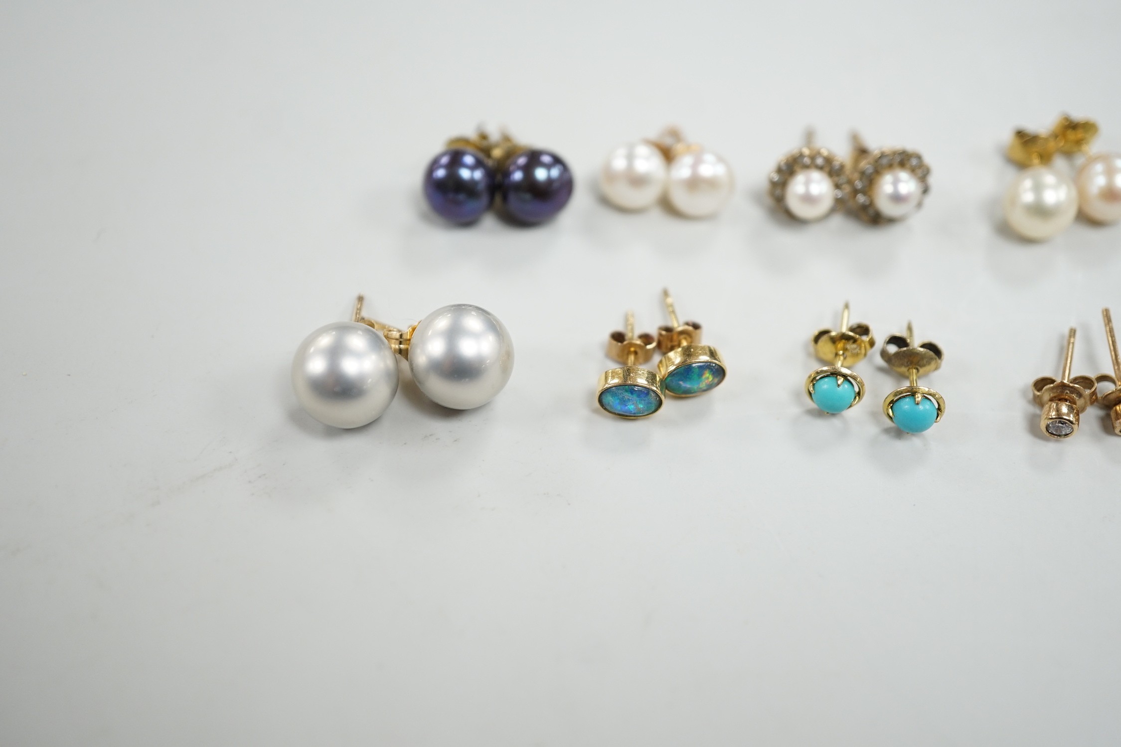 Eight assorted modern pairs of ear studs, including a 14k and cultured pearl and two other cultured pearl, one 9ct and diamond chip.